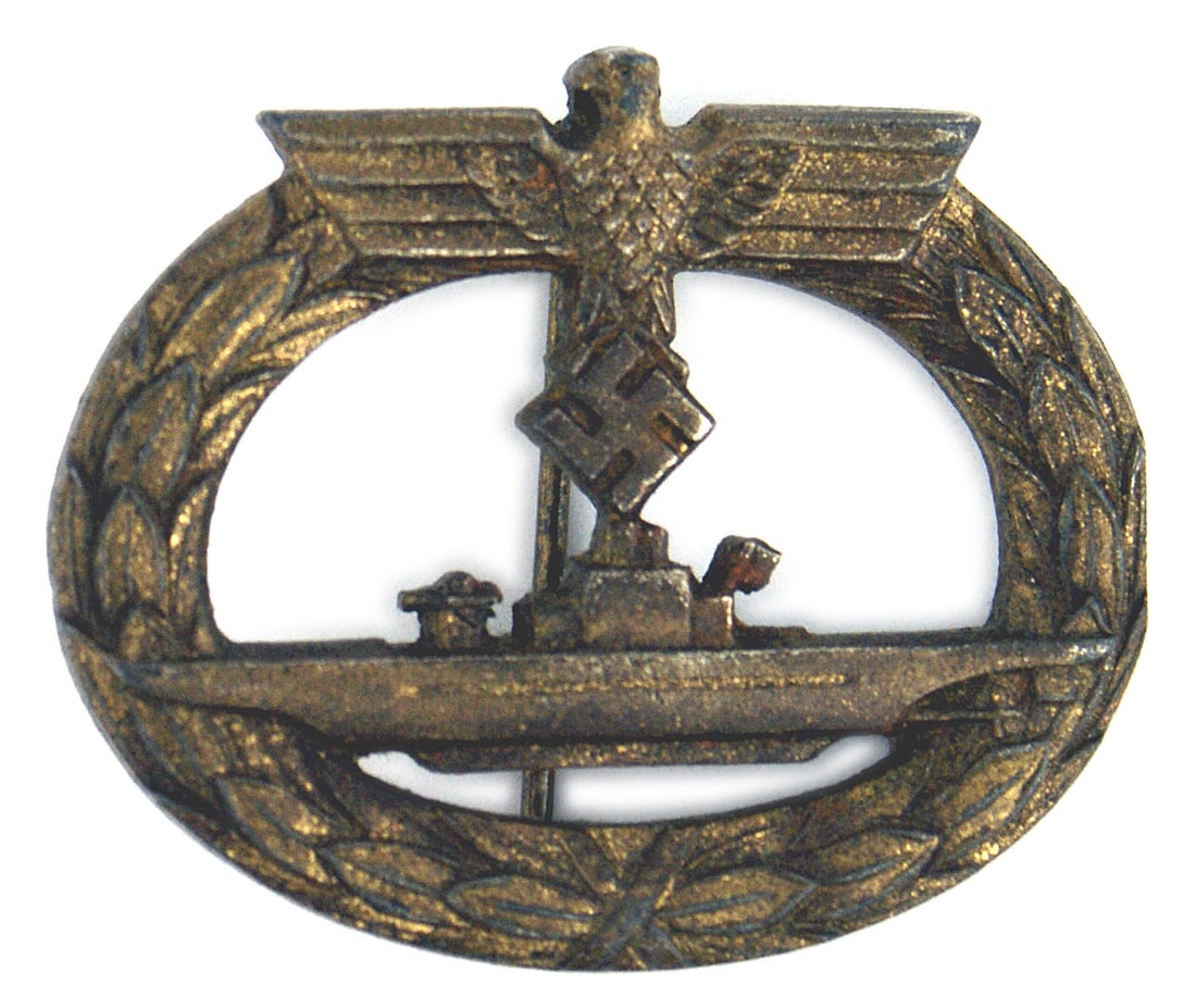 German WWII Navy Submarine Badge: B-075 German WWII Navy Submariner's Badge. Aged patina on the bronzed open oak leaves wreath holding a U-boat. Eagle/swastika (closed) at the top of the wreath. Vertical round pin on reverse. Maker's 