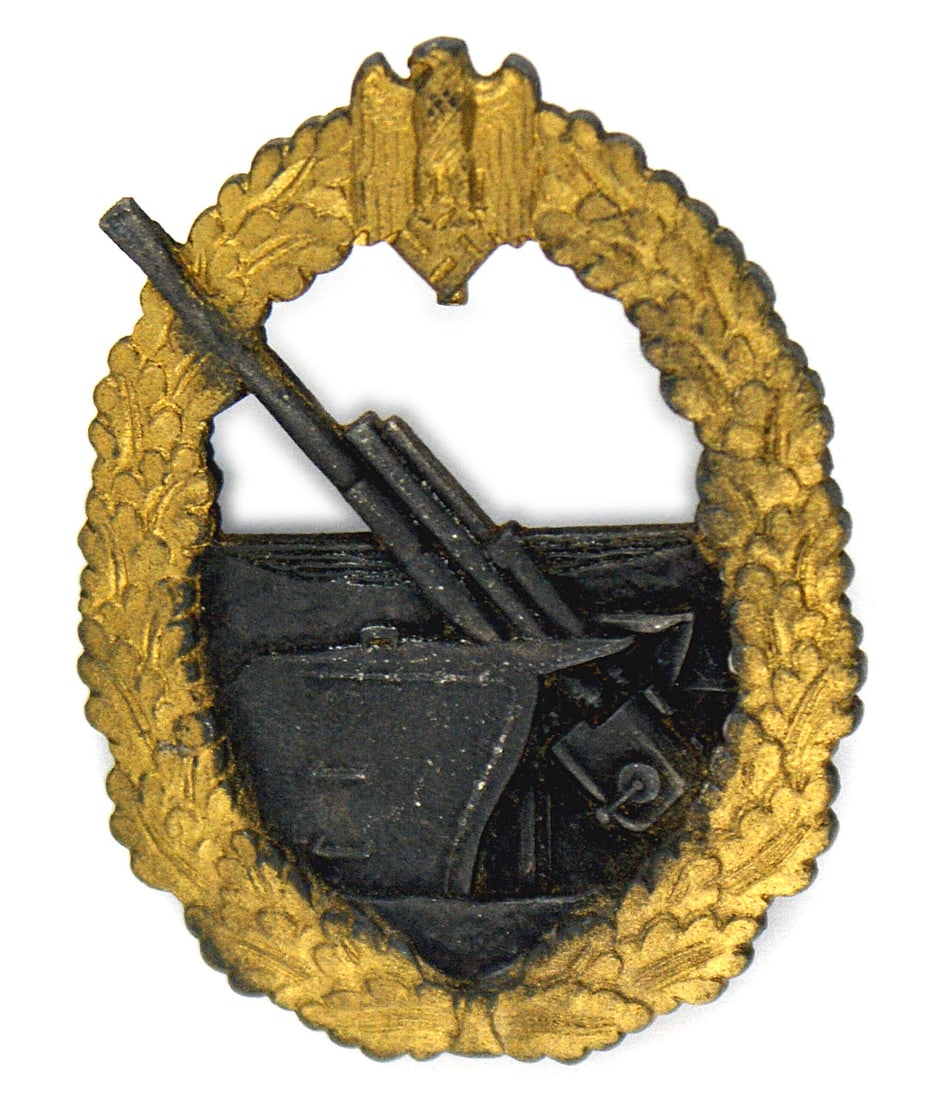 German WWII Navy Coastal Artillery Badge: B-080 German WWII Navy Coastal Artillery Badge. Made by the French firm of Baqueville. As with the German made badges, the French also have a relief feature. The oak leaves wreath with eagle/swastika 