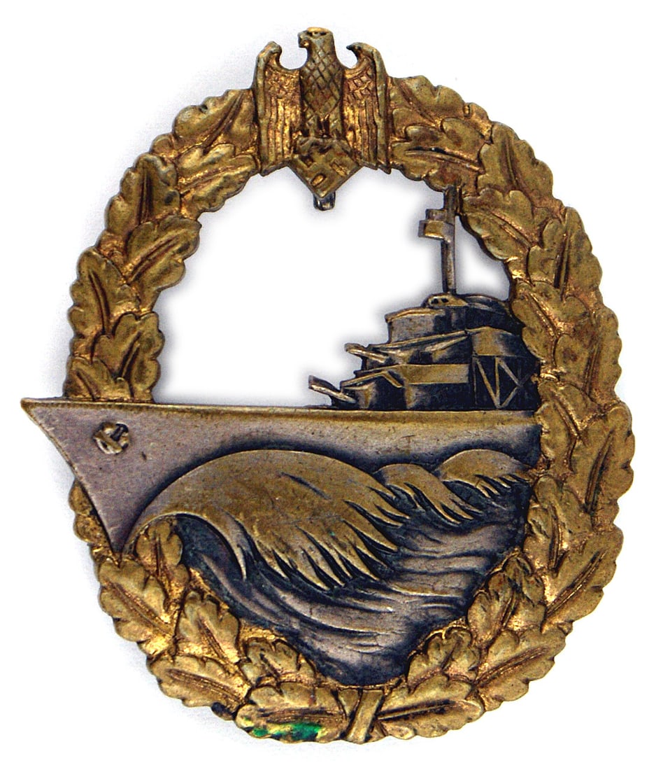 German WWII Navy Destroyer Badge: B-082 German WWII Navy Destroyer Badge. Nice patina on the gilt finish on wreath and darkened silver ship and waves. Silvered reverse with a flat horizontal pin and thread loop catch. II+