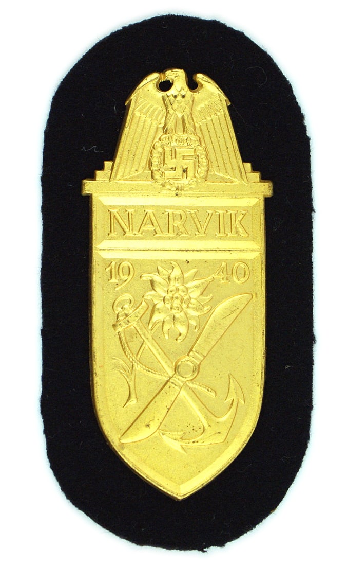 German WWII Navy NARVIK Shield: B-088 German WWII Navy "NARVIK" Shield - Gold. Eagle/swastika, "1940" and edelweiss/anchor/prop. Navy issue on dark blue cloth with metal plate and paper backing. (Issued for participation in the Norw