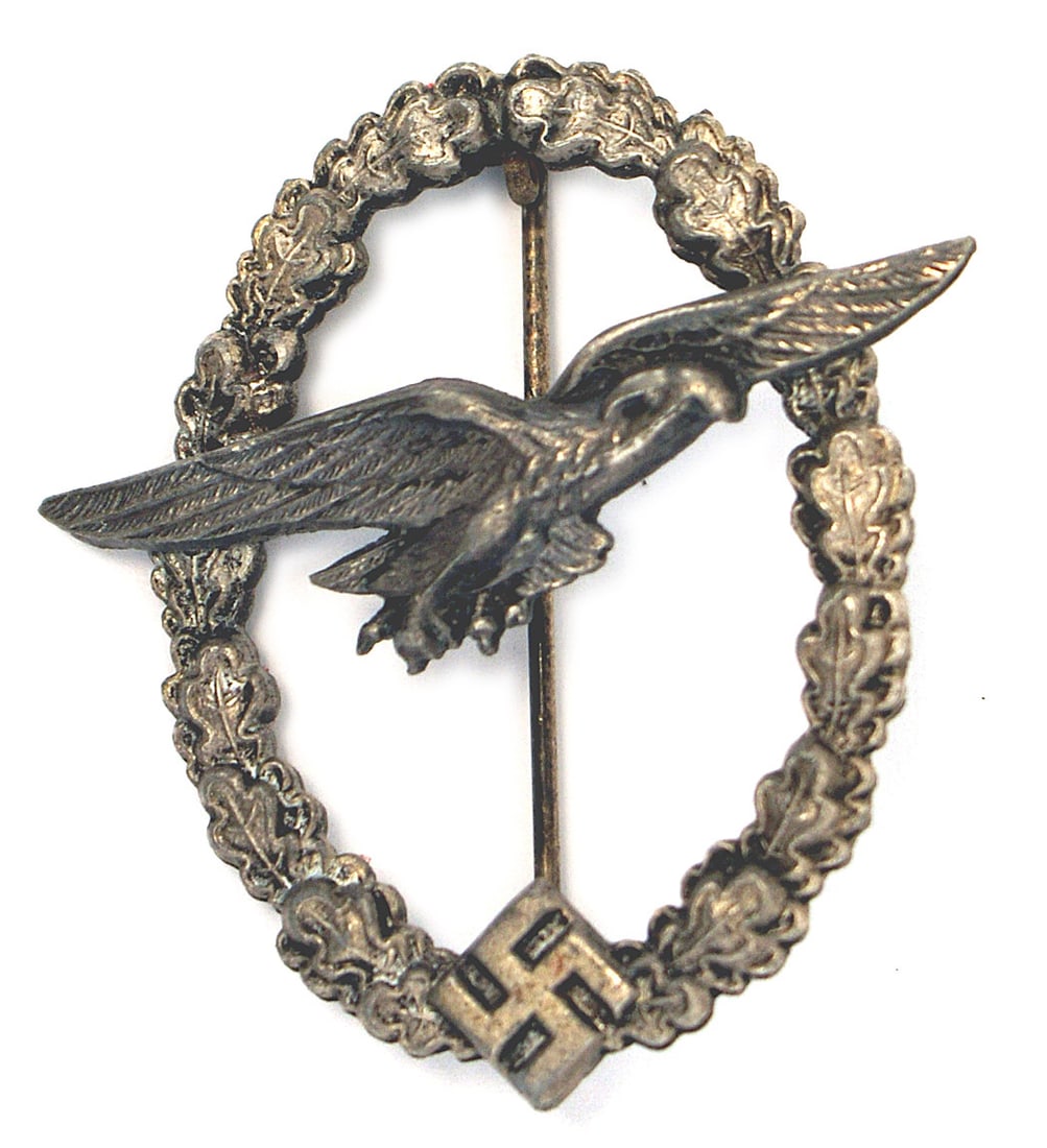 German WWII Luftwaffe Glider Pilot Badge: B-095 German WWII Luftwaffe Glider Pilot Badge. Eagle gliding across the upper area of the open (thin, well defined) oak leaf wreath. Solid type swastika at the base. Flat rivets on reverse. A quality