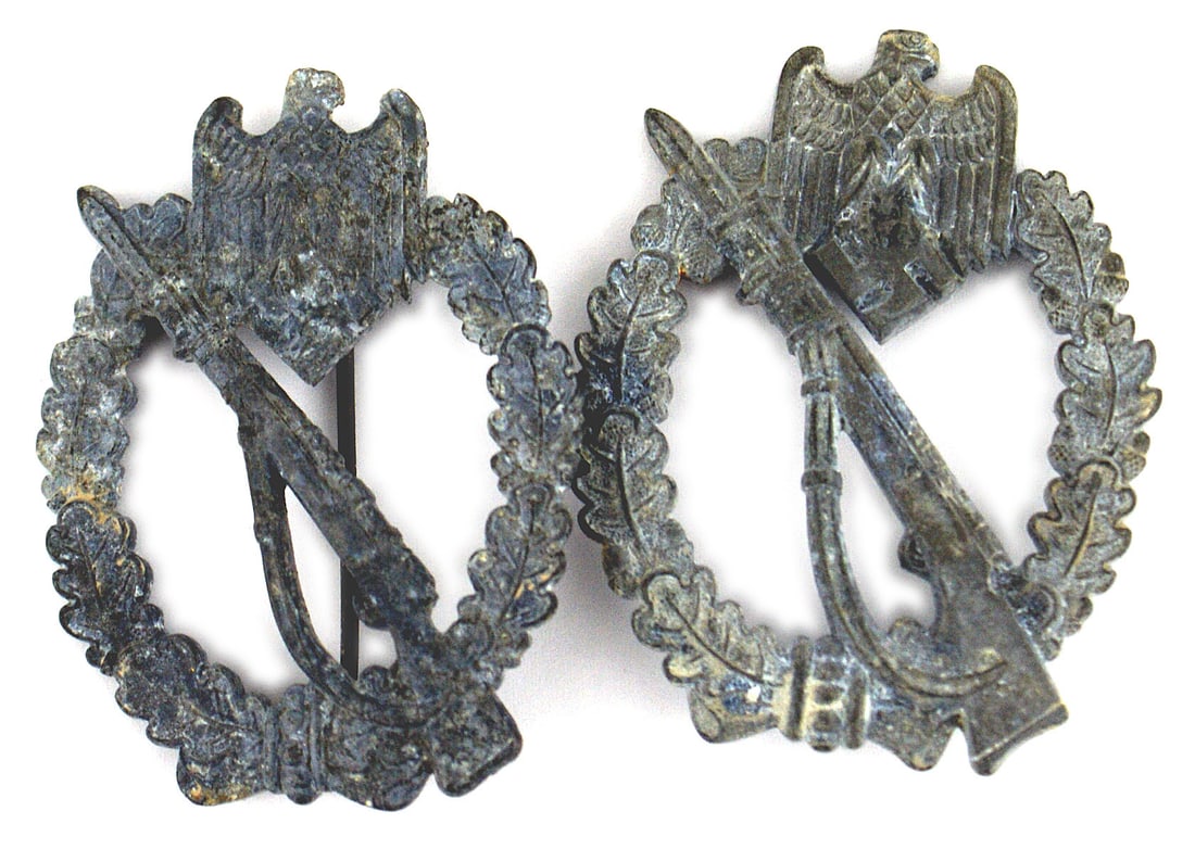 2 German WWII Infantry Assault Badges: B-101 Lot of 2 German WWII Infantry Assault Badges: Both wartime, made of zinc: (1) All gray metal with specks of the silver finish remaining. Reverse marked "L/10" ("FORESTER & BARTH" in Pforzheim). 