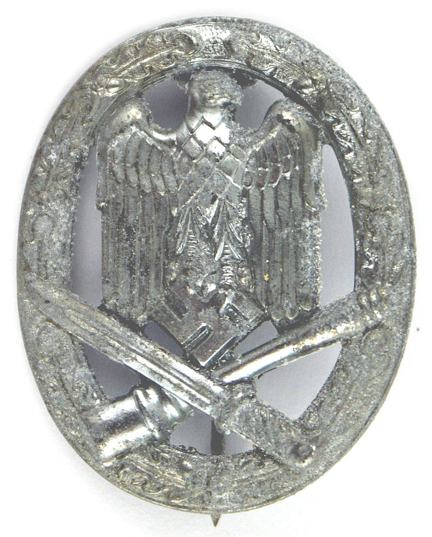 German WWII General Assault Badge wartime: B-103 German WWII General Assault Badge. Open oak leaf wreath holding an eagle/swastika over a crossed bayonet/stick grenade. Vertical pin on the reverse. Good detail. War time white metal - shows som