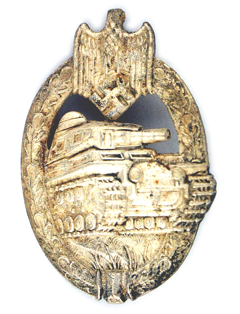 German WWII Panzer Assault Badge Silver: B-104 German WWII Panzer Badge - Silver. Excellent sculptured strike of an attacking tank within an open oak leaf wreath and eagle/swastika at the top - with 99% of the silver finish. Age darkened rev
