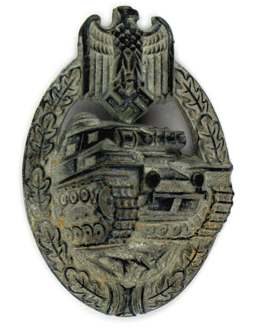 German WWII Panzer Assault Badge Silver: B-106 German WWII Panzer Badge - Silver. Attacking tank within an open oak leaf wreath - eagle/swastika at the top. Stamped variety. Finish has turned a dull silver-gray. II