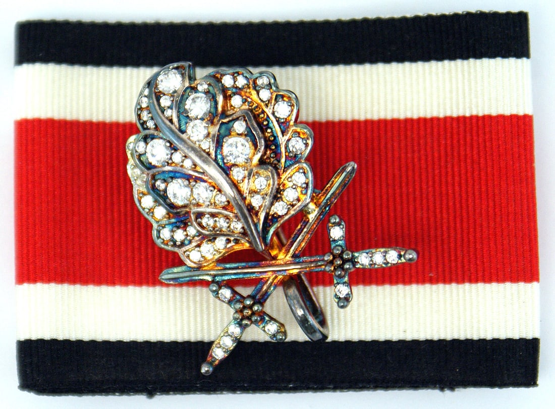 German 1957 Oak Leaves swords Brilliants: B-117 German 1957 Oak Leaves, swords and Brilliants. Made for the WWII Knights Cross recipients who lost or never received this higher award. The oak Leaves and Swords are slightly larger and have a r