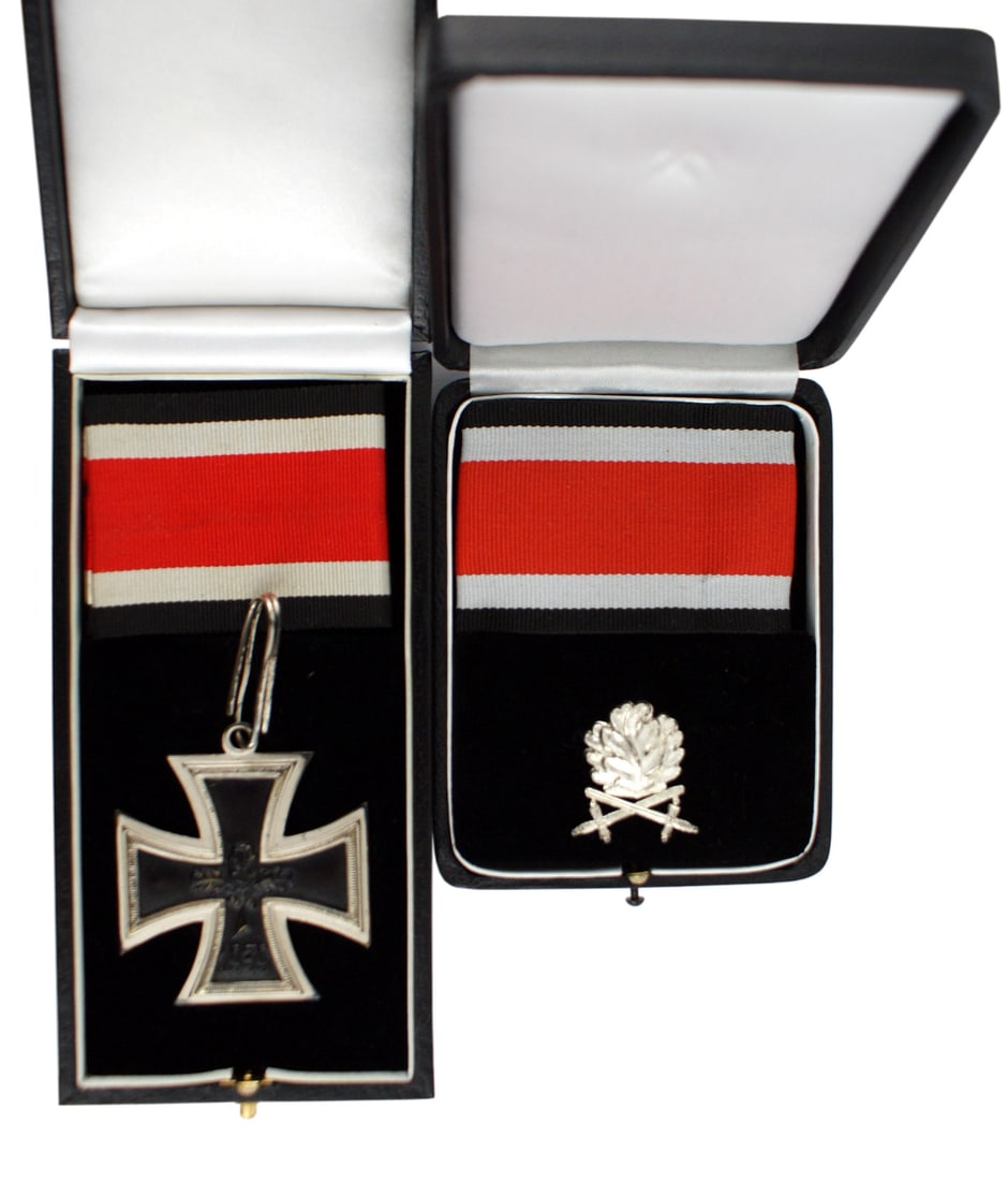 German 1957 lot of 2 WWII Knights Cross Oak Leaves: B-118 German 1957 lot of 2 WWII awards: (1) Knights Cross of the Iron Cross. There are three oak leaves and "1939" on the obverse of the black iron center. Reverse marked "1813". Leatherette case with