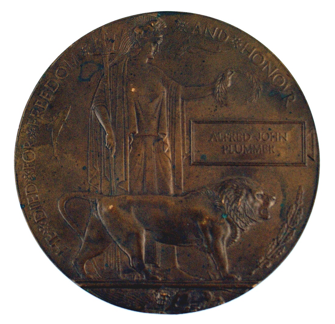 Great Britain WWI Death Penny: B-125 Great Britain WWI "Death Penny" bronze plaque. 4 3/4" diameter with an allegorical figure holding a laurel wreath over the name of the KIA, "ALFRED JOHN PLUMMER" and a standing lion. The perimet