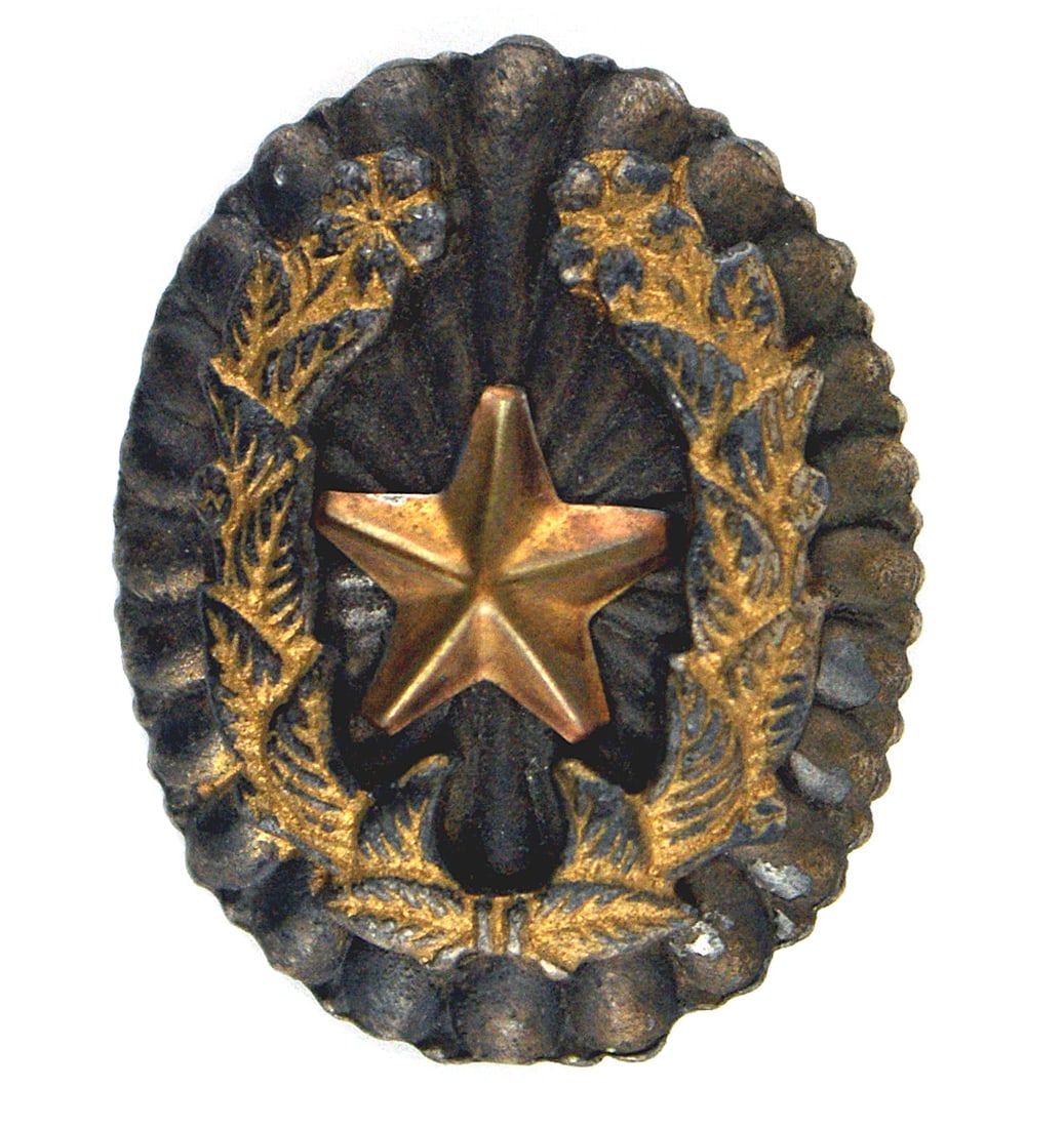 Japanese WWII Army General rank badge: B-170 Japanese WWII Army General's rank badge. High relief of a darkened silver leaf arrangement with an attached gilt floral wreath (has most of the gold finish), holding an aged, darkened gold star.