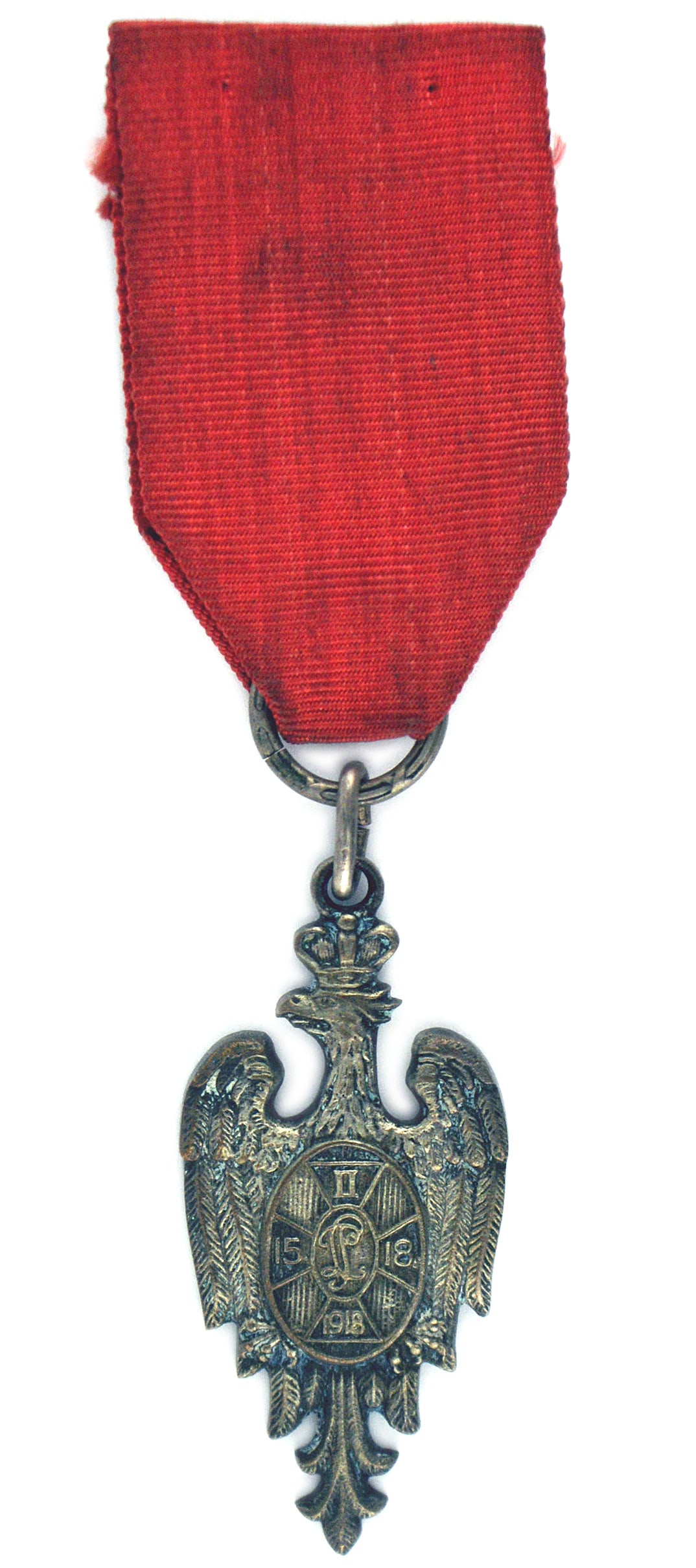 Poland WWI Prisoner of War Medal: B-183 Poland WWI Prisoner of War Medal. Awarded to all prisoners in Hungary. Crowned polish eagle with oval shield bearing a insignia of the second Joseph Pilsudski Brigade. Reverse has names of citie