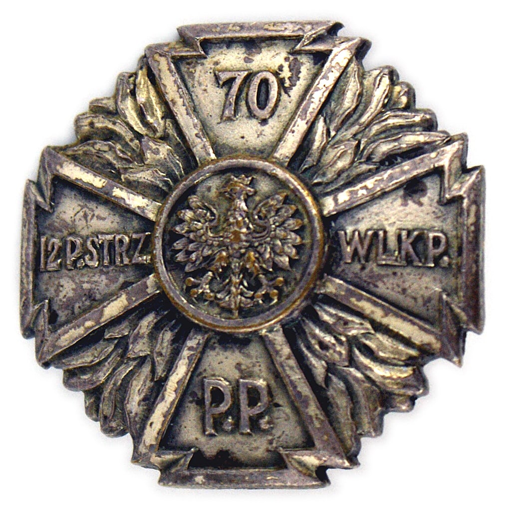 Poland 70th Infantry Regiment Badge: B-189 Poland. 70th Infantry Regiment Badge. Also known as the 12th Wielkupolski Regiment located at Pleszew. Convex silver cross with palms between the arms. "70", "12 P. STRZ", WIKP" AND "P.P." on ea