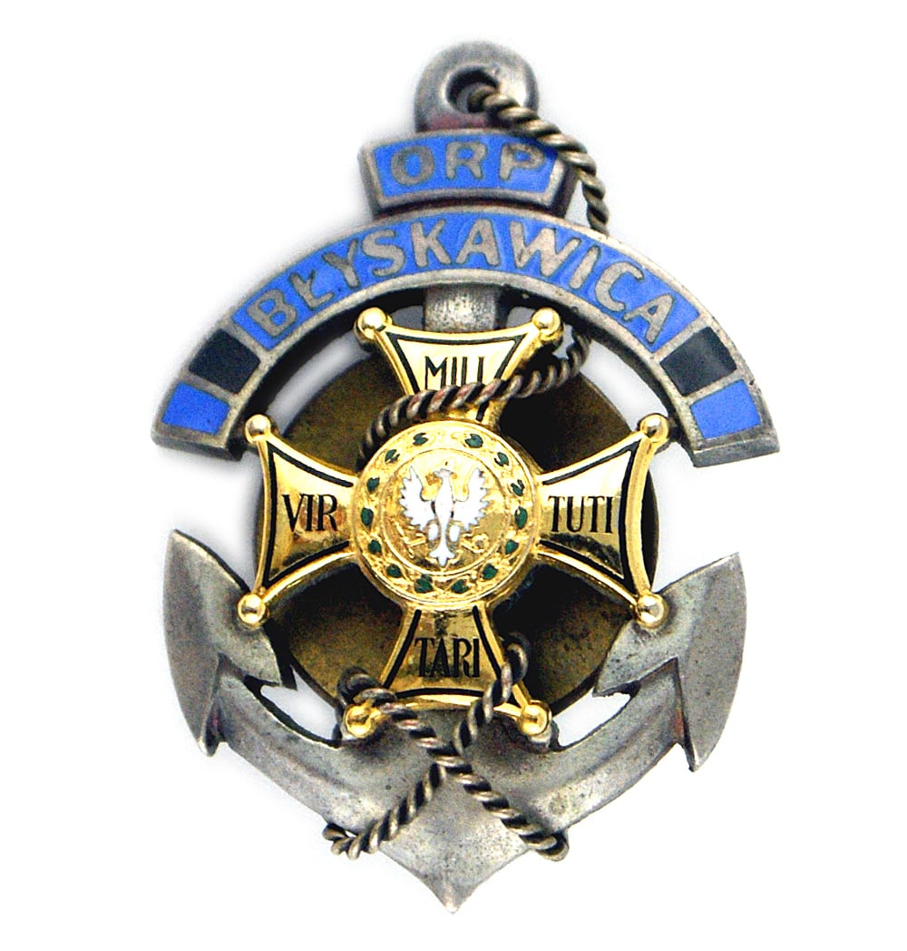 Poland Commemorative Badge Destroyer Blyska: B-192 Poland. Commemorative Badge of the Destroyer Blyska, the first Polish ship to engage the Germans in 1939. A blue enameled band with "BLYSKA" is above a small version of a gold Virtuti Militari, 