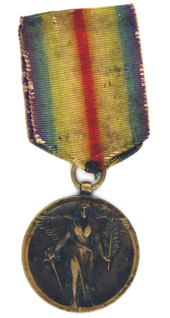Rumania WWI Victory Medal: B-205 Rumania. WWI Victory Medal. Obverse bears a winged allegorical figure holding a sword and a palm branch. Reverse has foliage and the names of 10 victorious Allied nations. A rare award. Medal an