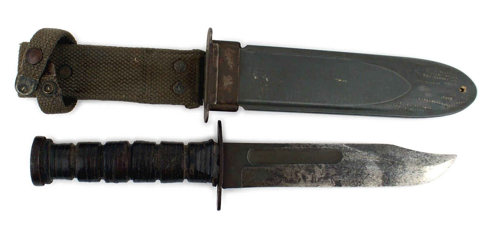 US WWII Navy Mark 2 knife: D-032 US WWII Navy Mark 2 knife. 1 2/8" wide, 6 7/8" blade has darkened with black "patches" from age and use. Crossguard is marked "USN" and "R. C. C." Leather washer grip is a little loose above the