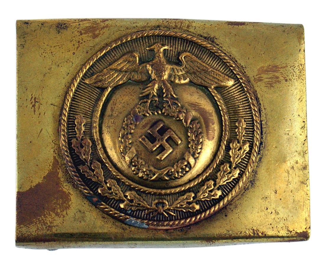 German WWII SA belt buckle: H-001 Third Reich SA belt buckle. Round front plate holds a variant larger type eagle which is positioned higher above the wreath holding the swastika. Two prongs and "goal post" and brace on reverse.