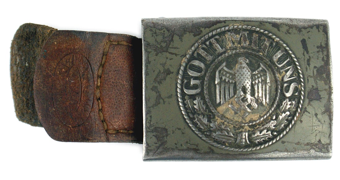 German WWII Army EM steel belt buckle: H-006 German Third Reich Army E.M. steel belt buckle. High relief eagle/swastika/oak leaves and "GOTT MIT UNS". 50% of the early light green finish remains. Reverse marked "1940". With a leather tab, 