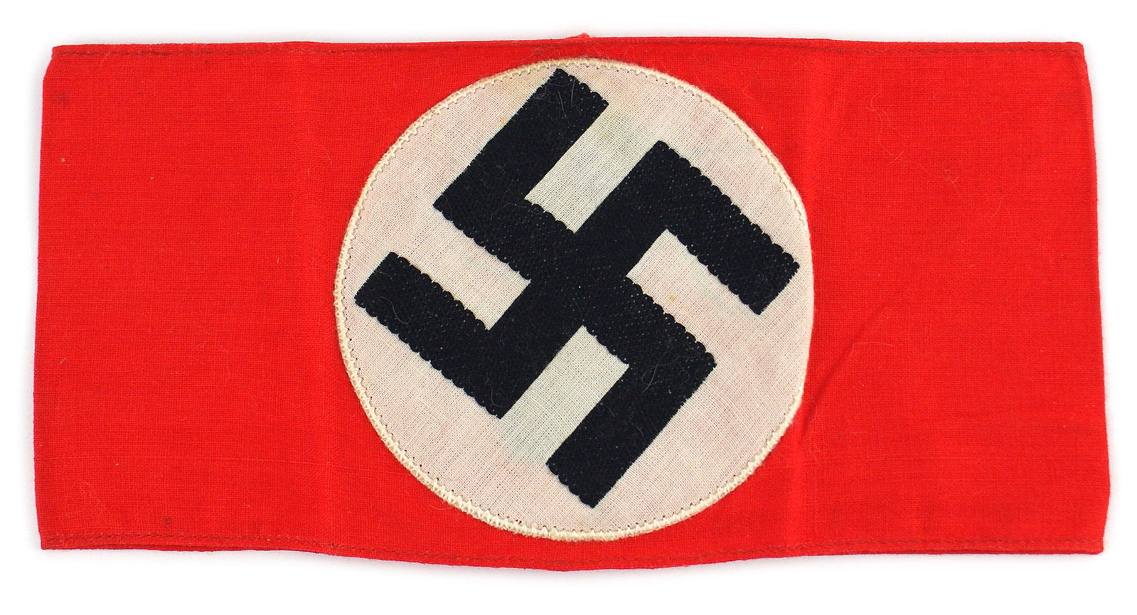 German WWII NSDAP armband: H-010 German Third-Reich N.S.D.A.P. armband. Embroidered black swastika on white roundel sewn to red field. Back of armband is ink stamped. "MSA Sch. N1", probably for a political school. I