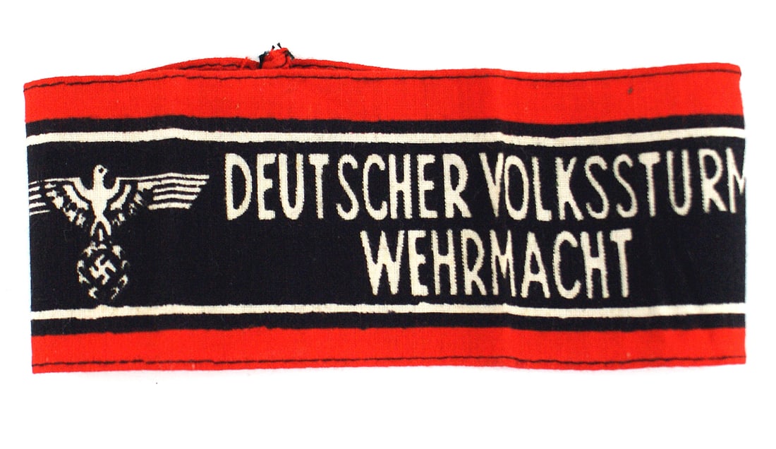 German WWII armband Peoples Army: H-018 German WWII armband of the "DEUTSCHER VOLKSSTRUM WEHRMACHT" (German People's Army). Red, white, and black printed on cotton with white lettering on black with two eagles and red borders. The las