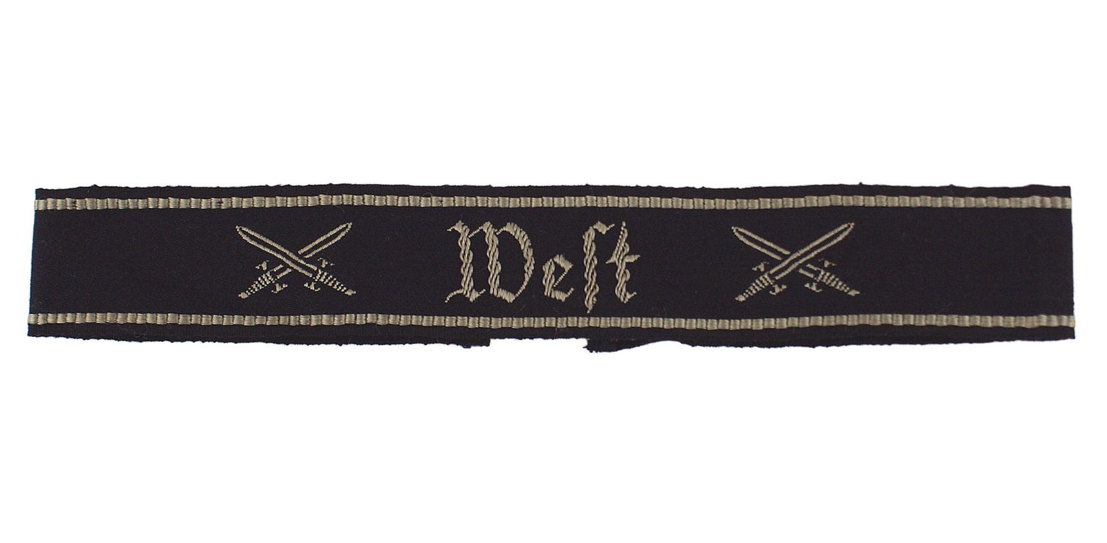 German WWII Reichskriegerbund West cufftitle: H-021 National Socialist Reichskriegerbund district "West" cufftitle, Silver-gray embroidered title flanked, on each side, by crossed swords and an inner border, on the black band. II