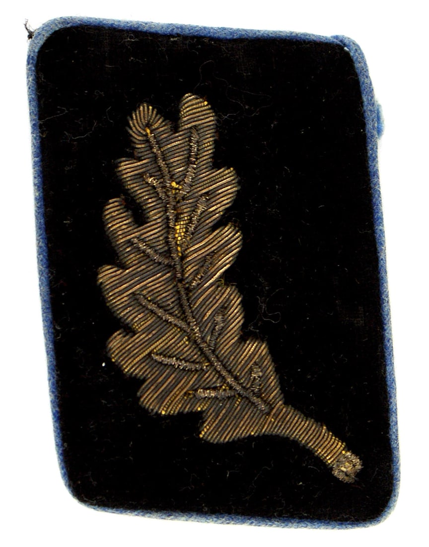 German WWII singlecollar tab Gau Party Court: H-034 Third-Reich single (left) collar tab for Gaugericht (Gau Party Court). Light blue piped black velvet tab with a single bullion oak leaf with no acorns. Paper label section with "RZM" on reverse.