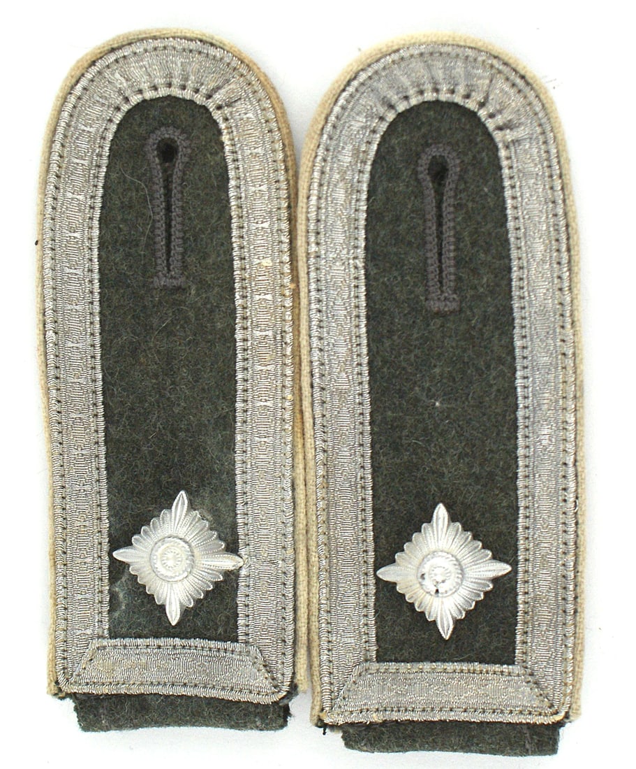 German WWII Army Infantry shoulder boards: H-037 German WWII Army Infantry slip-on shoulder boards. White piped feld-grau with one pip and silver tress inner border. Reverse of one board has a moth bite, otherwise very good plus. II+