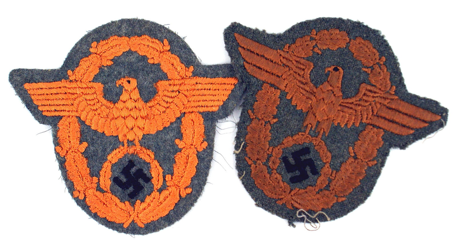 2 German WWII Feldgendarmerie sleeve eagles: H-040 Lot of 2 German WWII Feldgendarmerie sleeve eagles. Orange embroidered eagle/swastika on an orange oak leaf wreath. II