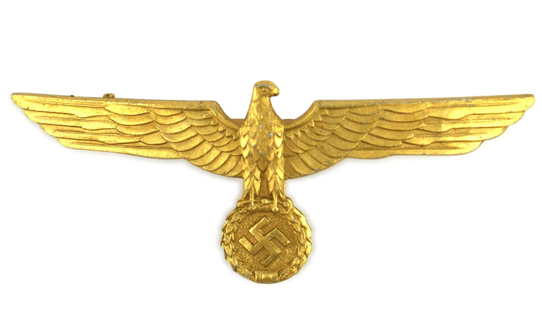 German WWII Navy officer breast eagle: H-042 German WWII Navy officer's gold breast eagle for a summer white tunic. Solid, non-metal 3 3/4" detailed eagle and swastika. 2 3/4" long horizontal pin with a 1/2" hook for a uniform loop. I