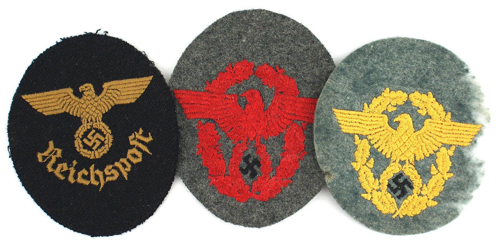 3 embroidered German WWII sleeve eagles: H-044 Lot of 3 embroidered Third-Reich sleeve eagles. (1) Fire Police - red Police eagle/oak leaf wreath on O.D. oval "patch" (2) Gendarmerie - light orange Police eagle on a oak leaf wreath. Mothing 