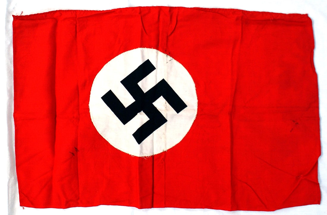 German WWII NSDAP banner: H-055 German Third Reich N.S.D.A.P. banner printed black swastika on a white roundel (probably was cleaned) was sewn to a 23" x 14" red field. Three nail holes on border. II