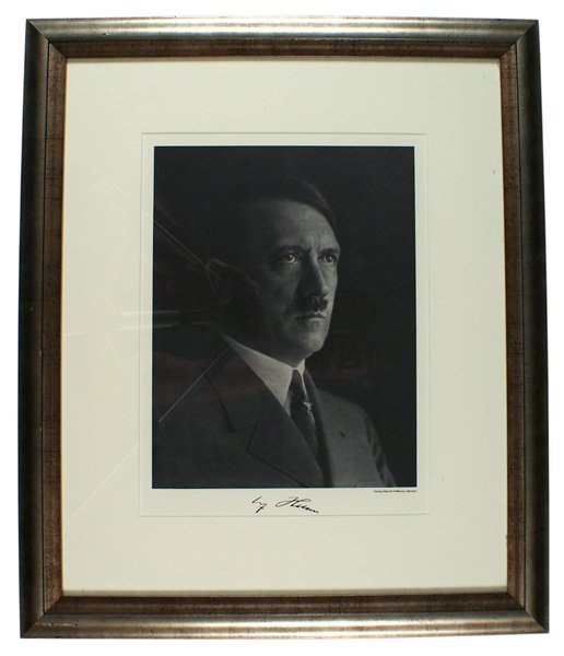 Heinrich Hoffmann print of Adolf Hitler: L-16 Original Heinrich Hoffmann portrait print of a serious looking Adolf Hitler. Border has a very realistic facsimile signature. Professionally matted and framed using an antiqued silver wood frame.