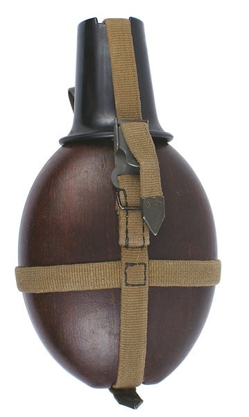 German WWII Afrika Korps canteen: N-1 Afrika Korps canteen. (Marked "D.R.G.M. - H.R.E. 42..."). Fiber body with a black plastic cup. OD web harness and belt strap. I