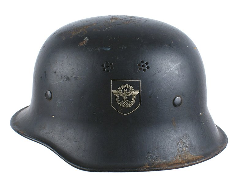 German WWII Fire Police helmet: E-40 German WWII Fire Police helmet - variant. Civil type with a short brim and rounded sides. Black finish is 85% intact. Police eagle decal and swastika shield are 99%. Edge of leather liner shows s