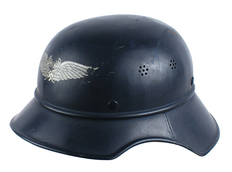 German WWII Luftschutz Gladiator helmet: E-44 Luftschutz "Gladiator" 3-piece helmet. Large front decal has some scratches on the tip of the left wing. Leather liner shows some expected wear. With leather chinstrap. Maker's information is sta