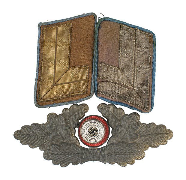 German WWII NSDAP wreath collar tabs lot: E-148 German WWII N.S.D.A.P. lot: (1) Age darkened oak leaf cap wreath with an enameled swastika rosette. (2) Two political leader collar tabs. Show wear. II