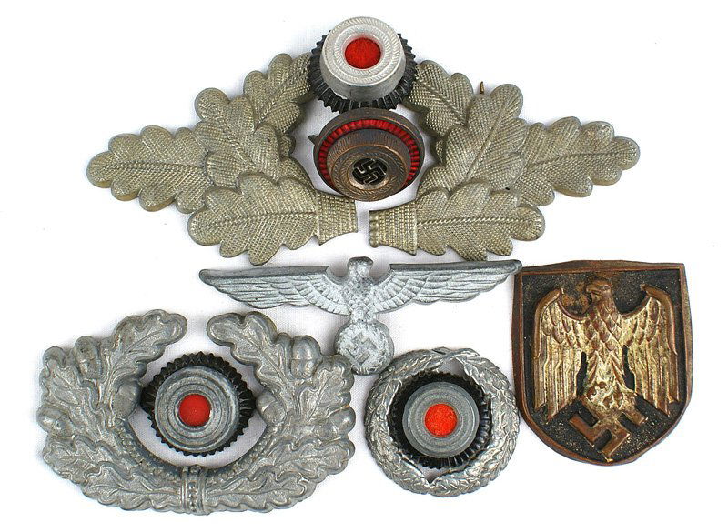 German WWII peaked cap insignia lot: E-153 Metal German WWII peaked cap and miscellaneous insignia: (1) Army eagle/swastika, cap wreath, rosette, AK pith helmet eagle shield. (2) Postschutz rosette/wreath. (3) NSDAP long wreath (broken)