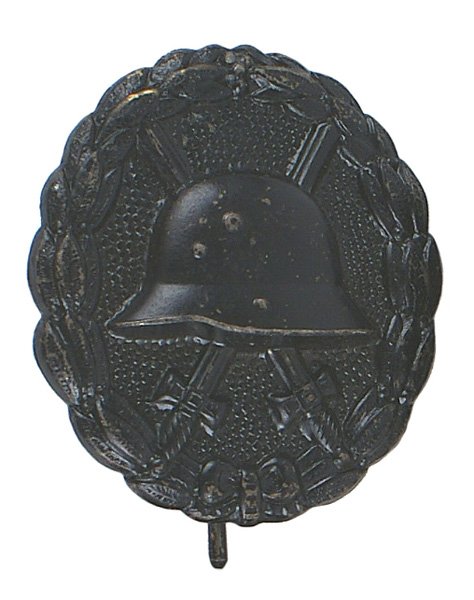 German WWI Wound Badge Black medal: B-10 German WWI Wound Badge - Black. Relief helmet/crossed swords on a stippled background - bordered by a relief oak leaf wreath. Minor wear. II