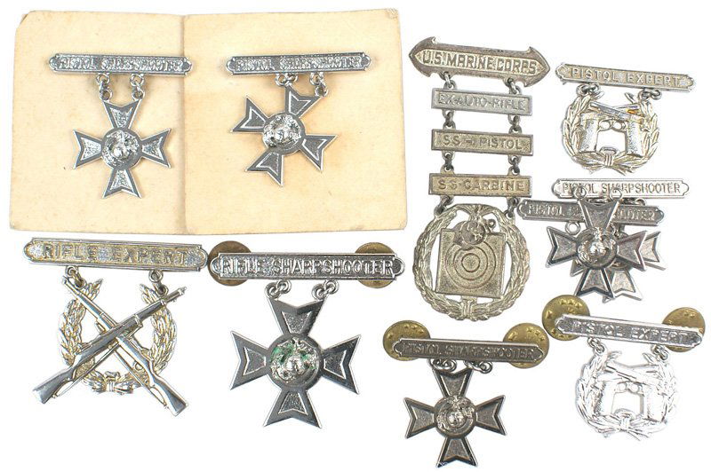 Lot of 10 USMC STERLING shooting badges: B-153 Lot of 10 U.S.M.C. "STERLING" shooting qualification badges: (1) 5 "PISTOL SHARPSHOOTER". (2) Two "PISTOL EXPERT". (3) "RIFLE SHARPSHOOTER". (4) "RIFLE EXPERT". (5) WWII "U.S. MARINE CORPS" "lad