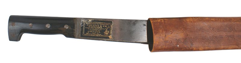 Lot 2 Spanish-American War machetes: D-27 Lot of 2 Spanish-American War machetes: (1) "...COLLINS & CO..." marked wide, 22" blade. Paper label still attached. Composition grip. Tooled leather scabbard shows some wear. (2) Stylized bone g