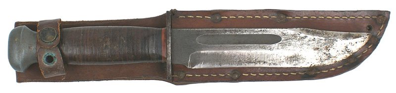 U.S. WWII combat knife: D-35 U.S. WWII combat knife. Oval metal pommel and short crossguard with a leather rings grip. 6 1/4" blade shows wear - most of the parkerized finish is gone. Marked "RH - PAL - 36". Leather scabbard