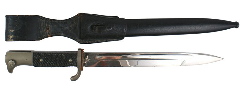 German WWII Army parade dress bayonet: D-86 German Army Third-Reich parade dress bayonet. Clean 9 3/4" blade - marked with knight's helmet logo and "WKC". Light wear on the black enameled scabbard. Black leather dress frog. II