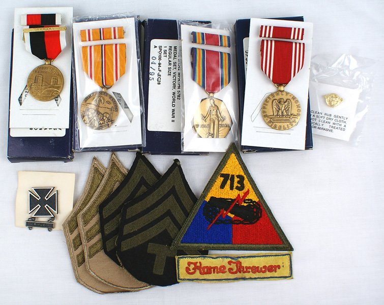 U.S. WWII Tank Battalion Flame Thrower insignia: S-9 Lot from Tech Sgt. John J. Manning Jr. : (1) Embroidered insignia: 713th Tank Battalion with a "Flame Thrower" legend and pairs of Summer and Fall Tech Sgt. chevrons. (2) 1990s replacement medals: