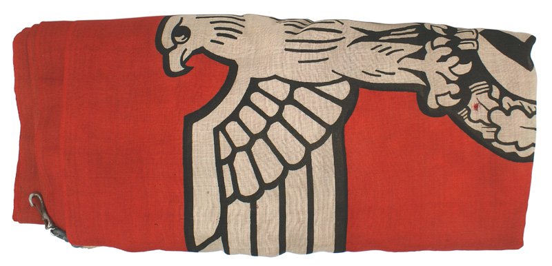 German WWII Military Garrison flag: H-131 Military Garrison flag. Massive white outlined black swastika within a white circle. Large black outlined white eagle/swastika in left corner. Both corners have a sewn-in rope loop with a metal 