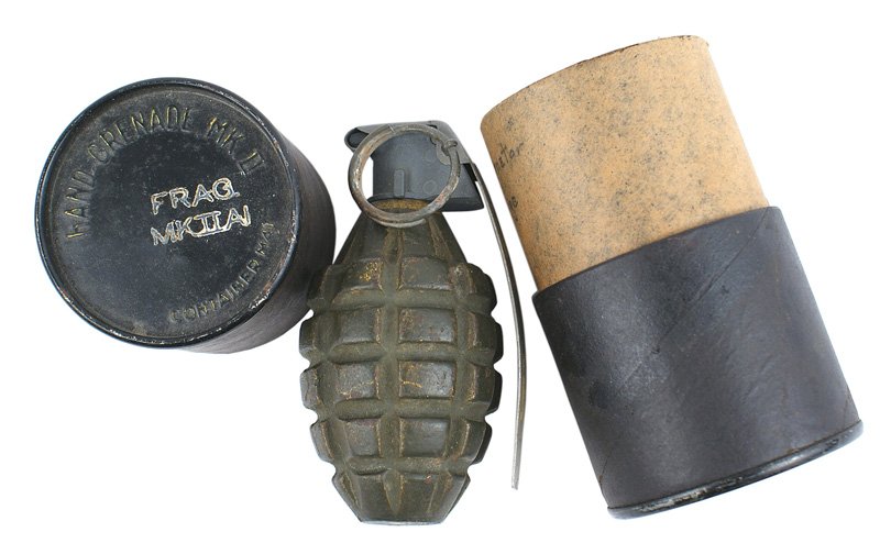 U.S. MK-II grenade with original shipping cylinder: M-085 Single MK-II grenade, with a green finish, and the original cardboard shipping cylinder. Metal top and bottom are marked "HAND GRENADE. MK. II." and "FRAG. MK II A1". Scarce. II