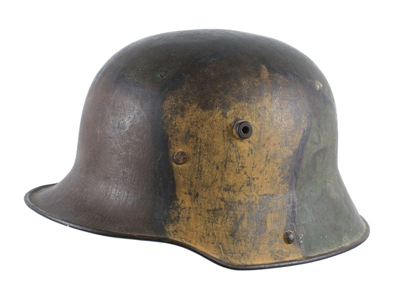 German M1916 camo helmet: E-017 German M1916 camouflage helmet. Large green/brown/yellow panels divided by black outlines. Leather liner is intact and supple. No chinstrap. II
