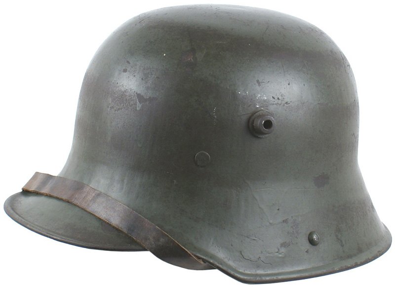 German WWI M1917 Stahlhelm helmet: E-020 German M1917 "Stahlhelm". Over 60% of the green finish remains. Brown leather chinstrap with brass fittings. Leather chinstrap with three-pad liner - front one shows some wear. Ink stamped "64" 
