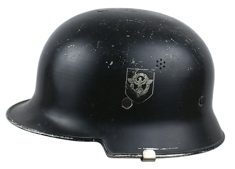 German WWII Fire-Police duck-bill helmet: E-043 German WWII Fire-Police "duck-bill" helmet. Steel body with 85% Police eagle/swastika on left side and swastika/shield (90%) on right side. Black body showing some wear and scuffs on top. Slots 