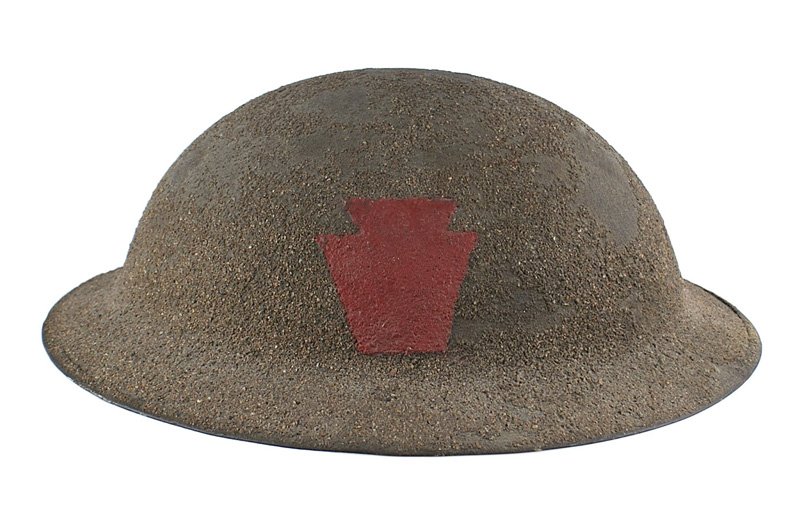 U.S. WWI doughboy 28th Division painted helmet: E-064 U.S. WWI "doughboy" 28th Division "painted" helmet. O.D. heavy sand finish with a red keystone painted on the front. Leather chinstrap and liner intact. II