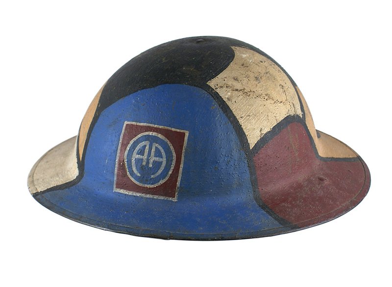 U.S. WWI 82nd Division painted camo helmet: E-073 U.S. WWI "doughboy" 82nd Division "painted" camouflage helmet. O.D. sand finish with vibrant colored panels of blue/white/tan/black/green/ and maroon. Back to back "A's" on a blue circle within