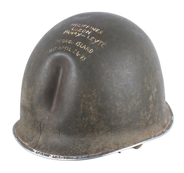 Interesting U.S. WWII combat souvenir helmet: E-090 Interesting U.S. WWII combat souvenir helmet. Fixed bale, "split" front seam with a pronounced "trench" created from the path of a Japanese bullet up the front which also left 2 splits. Period w