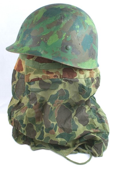 Lot of 2 U.S. WWII helmet liner USMC cover: E-104 Lot of 2: (1) U.S. WWII helmet liner. Painted in green camouflage - probably post-war. (2) USMC camo pattern camouflage helmet/neck cover. With ties. II
